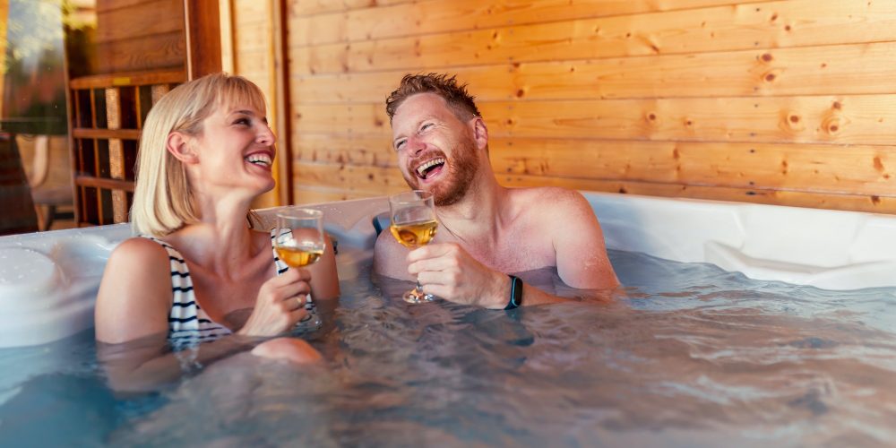 Couple relaxing and drinking wine in a hot tub
